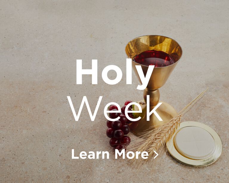 A zoomed out image of a gold chalice half-full of red wine. On the left next to the chalice are red grapes, on the right is a piece of wheat. To the right of that is a gold plate that holds a large host. Image links to Holy Week page.